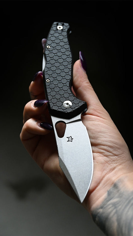Fox Knives EDC folder with textured black handle held in hand